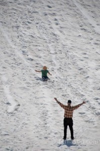 Jordan sliding down the snow at Crater Lake NP