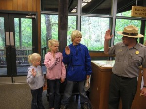 Kids take the Junior Ranger oath with the Ranger in Olympic National Park