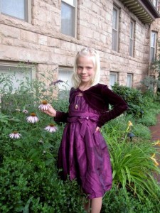 Carlye admiring the purple flowers